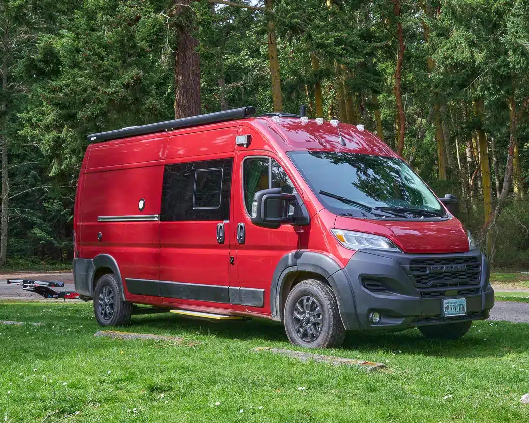 Beautiful interior of a professionally converted off-grid ready RAM ProMaster van from the team of Camp N Car located in Port Townsend on Washington's Olympic Peninsula the red van exterior