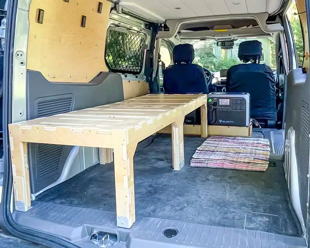 Cozy small but mighty Ford Transit Connect Camper van with battery, fridge, bed and more. Converted by Camp N Car in Port Townsend Washington.