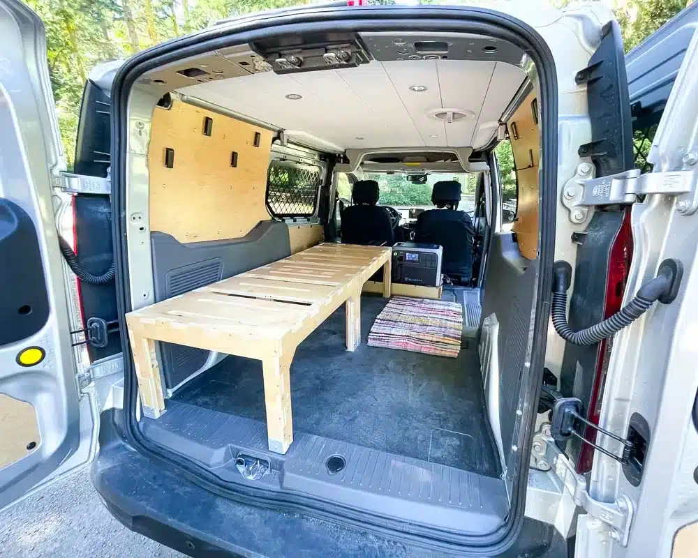 Cozy small but mighty Ford Transit Connect Camper van with battery, fridge, bed and more. Converted by Camp N Car in Port Townsend Washington.