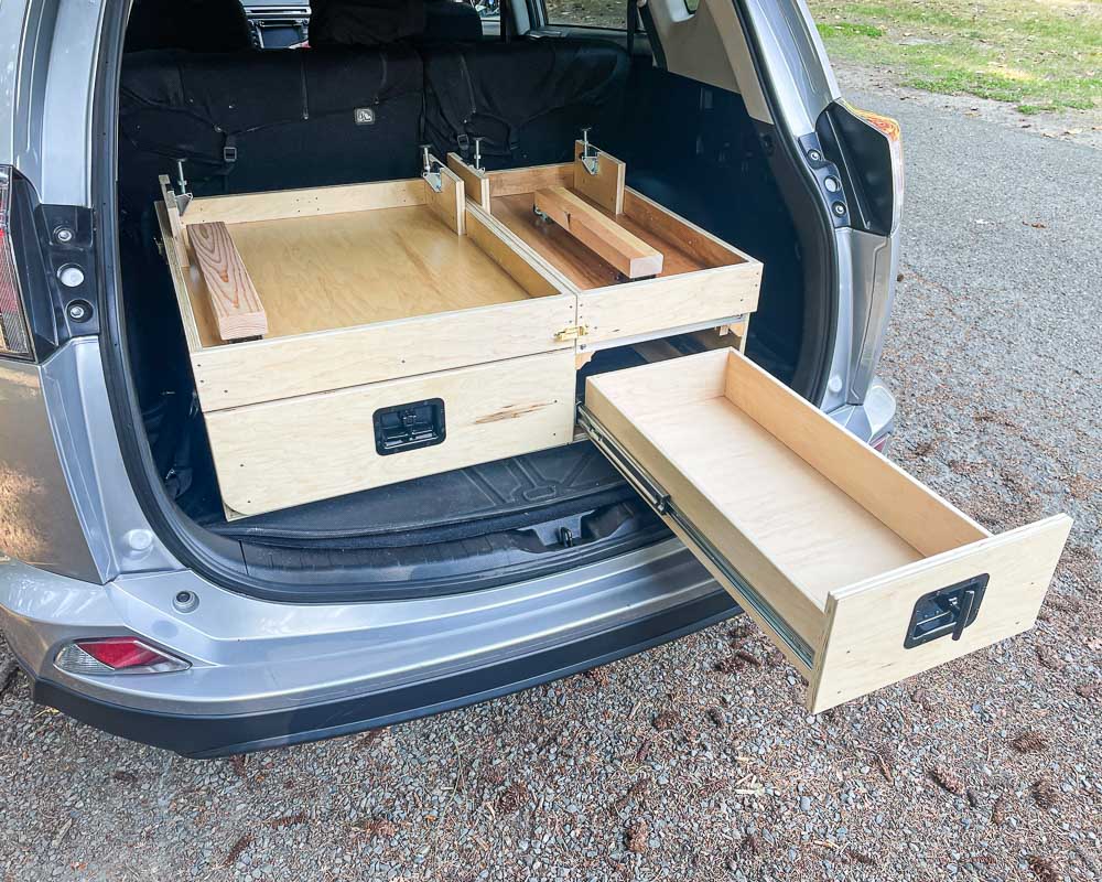 Amazing camper build for comfortable sleeping in a 2017 Toyota RAV4 that stows away in the rear cargo area made by the conversion shop of Camp N Car in Port Townsend Washington.