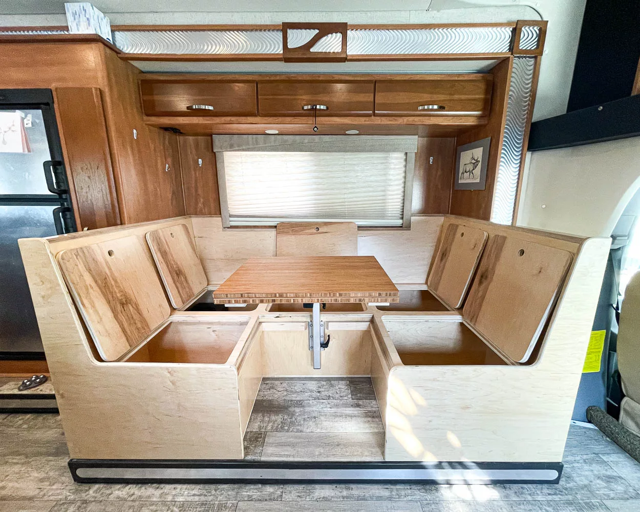 RV booth dinette upgrade in a Sprinter Chassis RV featuring extra storage, swivel table and easy conversion to a bed.